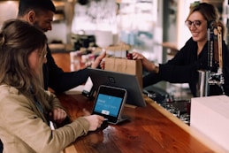 people using devices on brown table