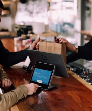 people using devices on brown table