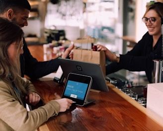 people using devices on brown table