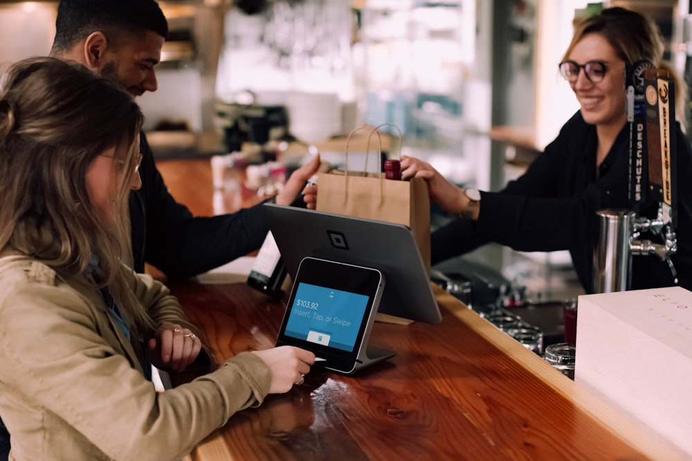 people using devices on brown table