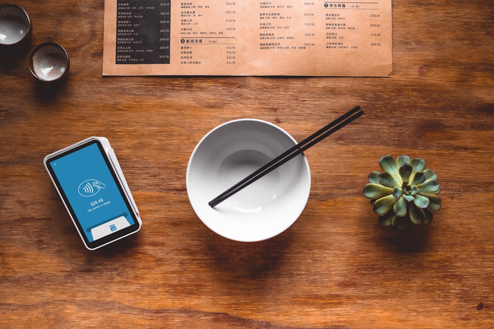 black chopsticks in white ceramic bowl on table