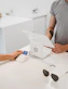 person using white tablet computer on table