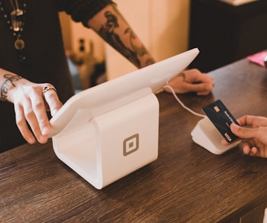 person holding white POS machine