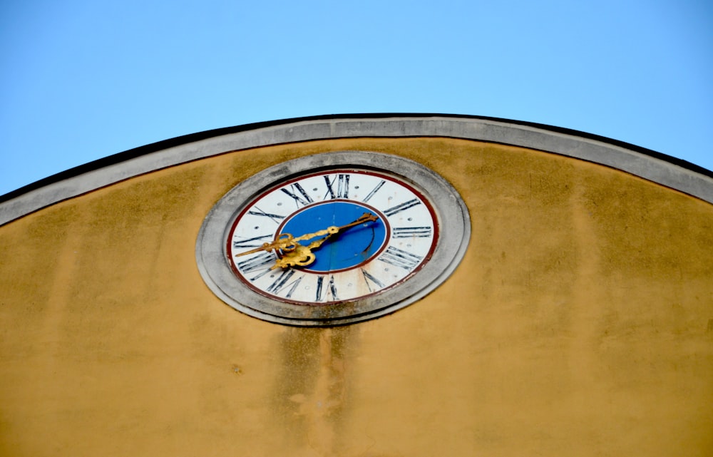 round white and blue analog wall clock