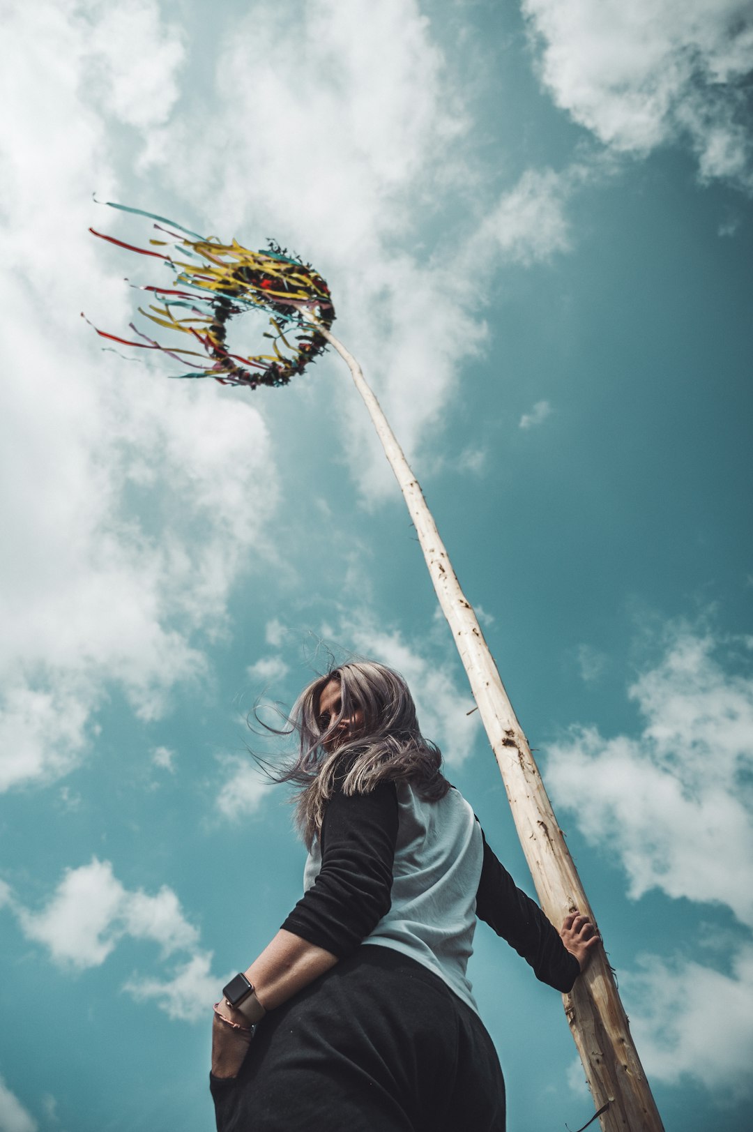 woman standing near pole