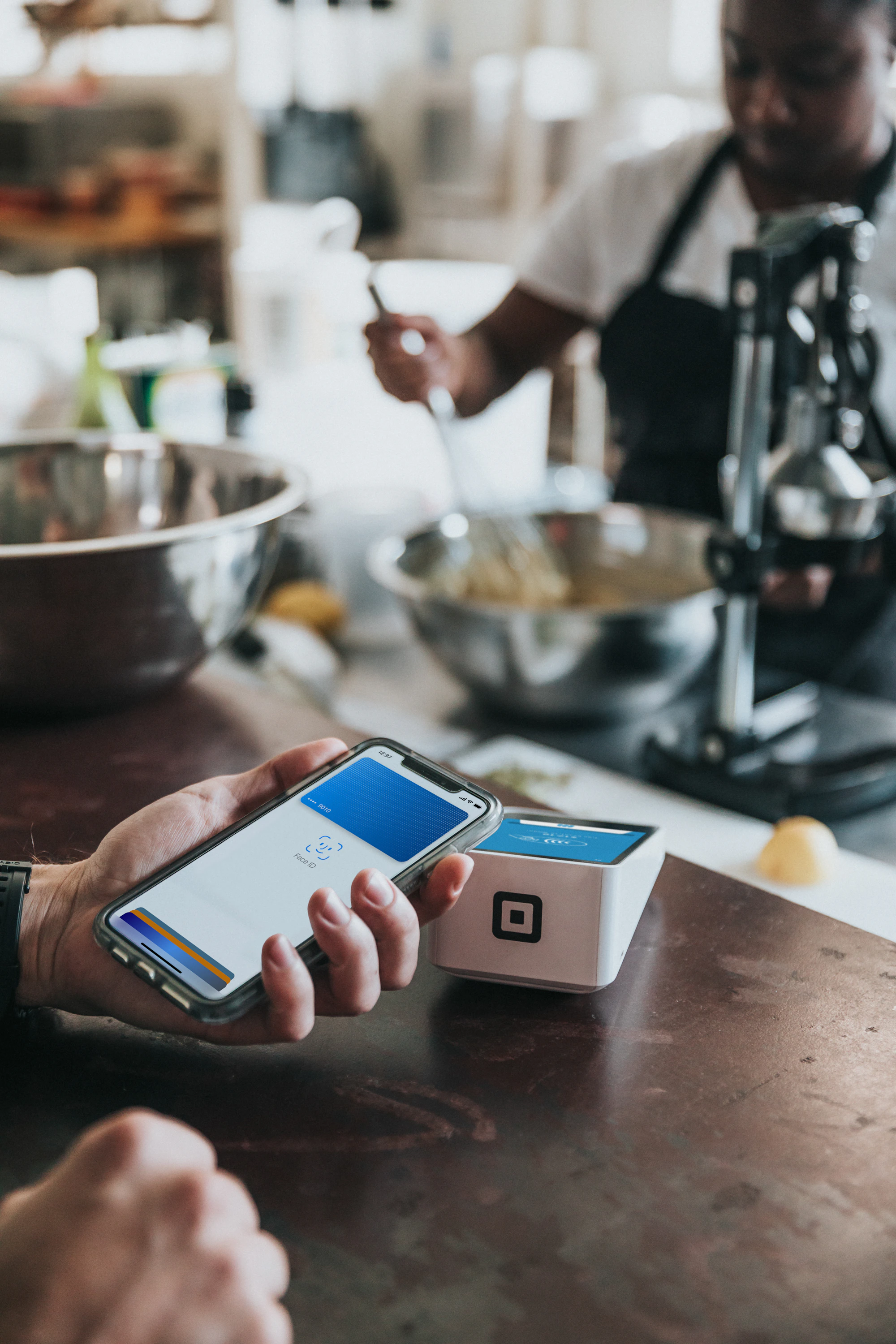 Small business owner using modern payment technology
