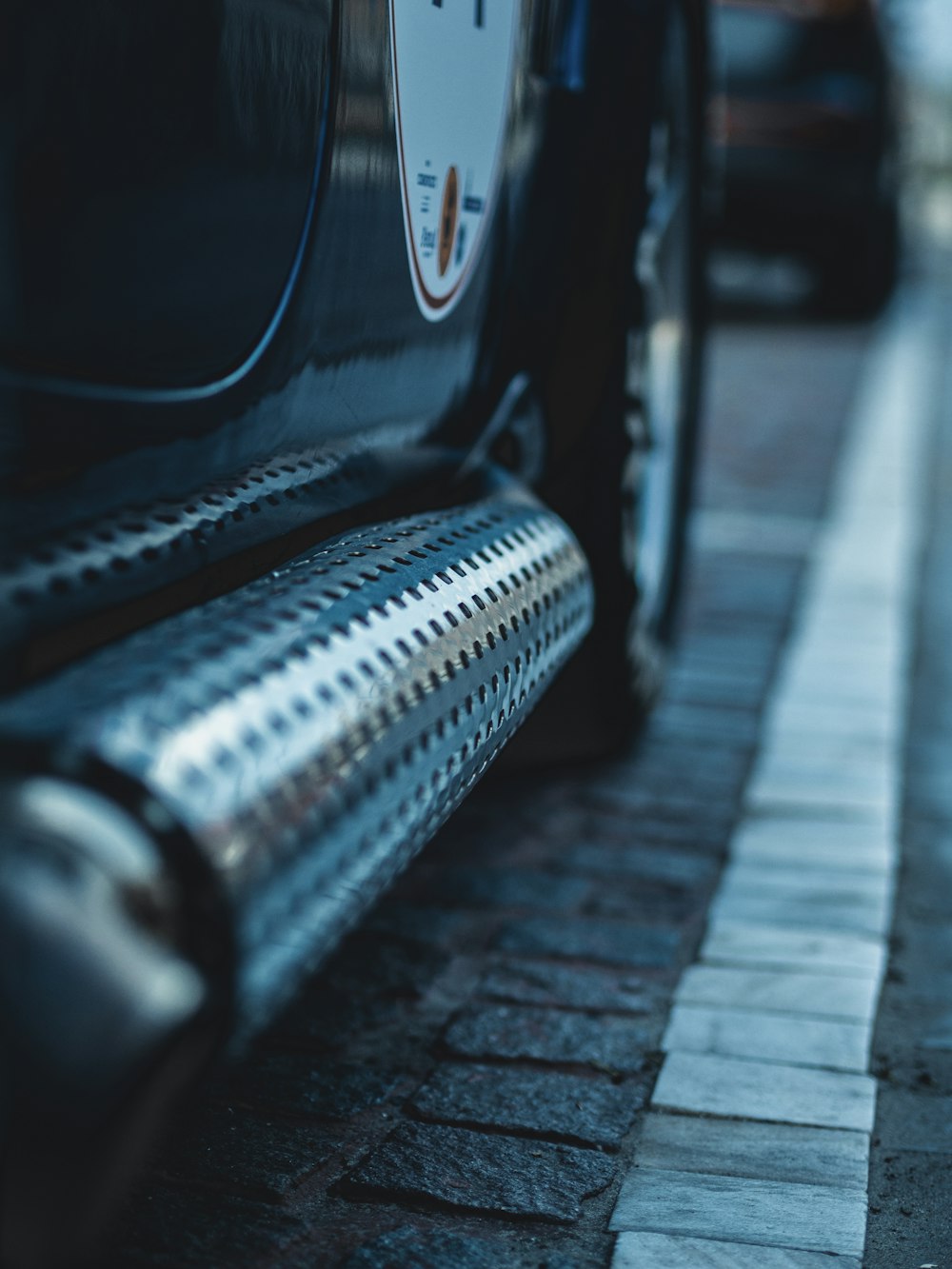 black vehicle on brick road