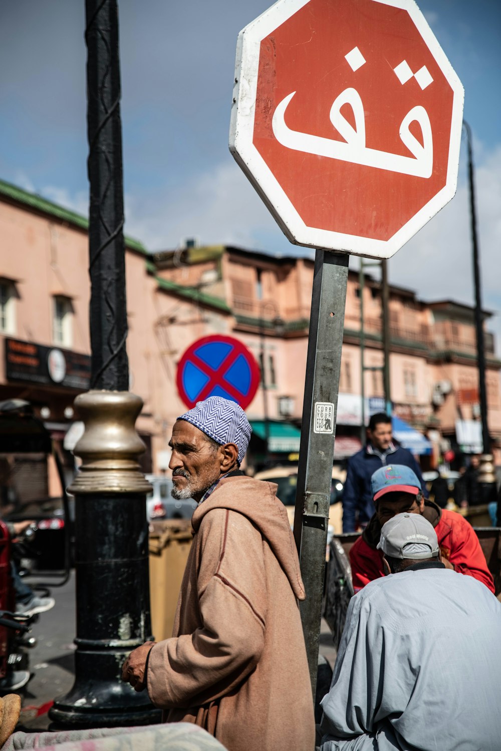 man standing beside street signage