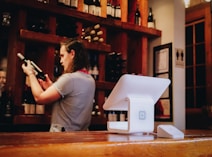 woman standing and looking on bottle