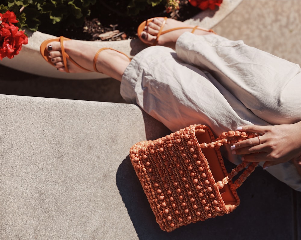 person holding orange woven basket