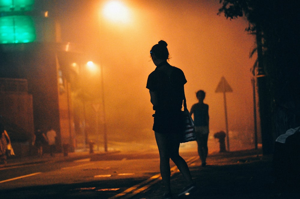 woman standing beside road