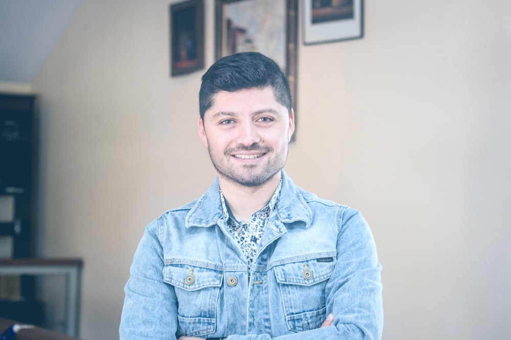 man wearing blue denim jacket