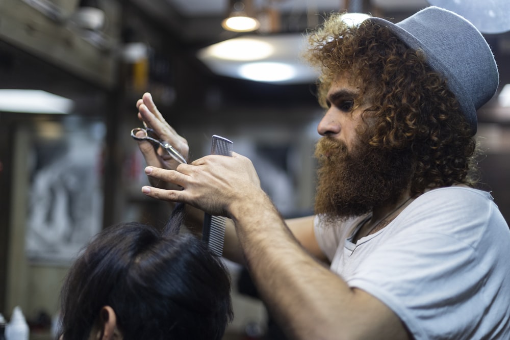 man cutting hair of woman