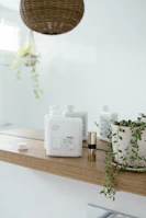 Minimalist bathroom shelf displaying euni bundles with subtle black accents and natural light.
