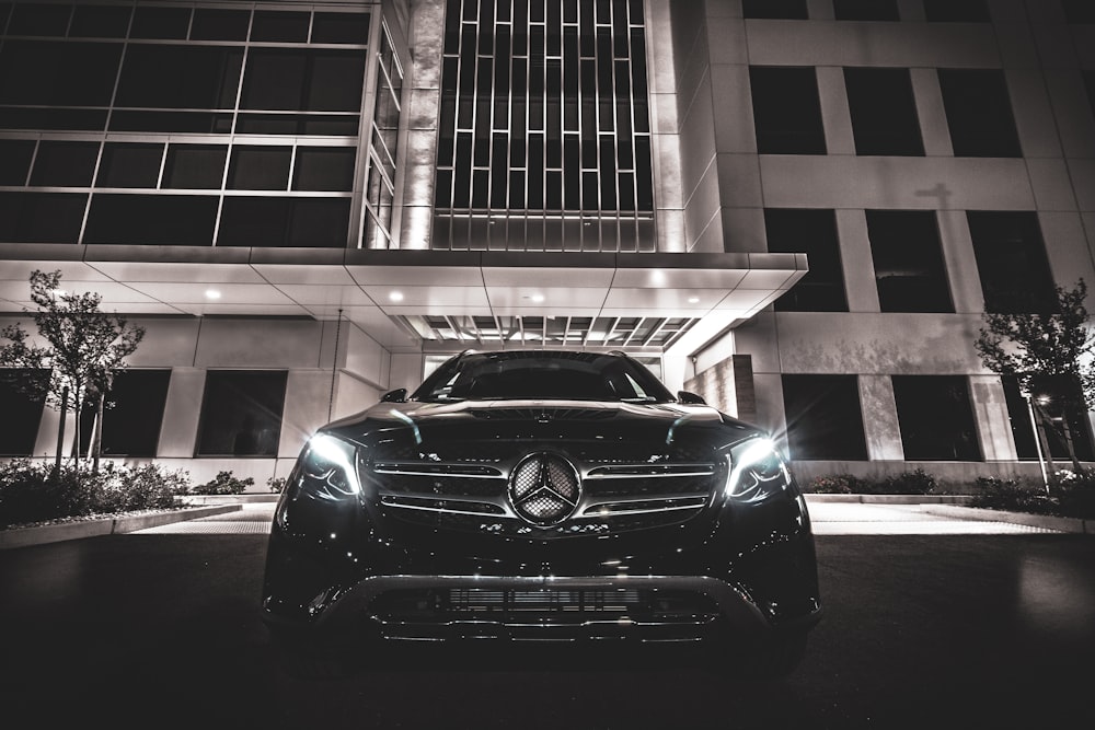 black Mercedes-Benz near building