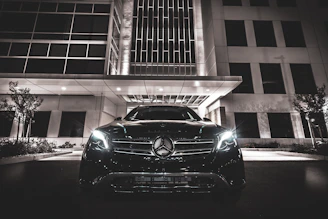 black Mercedes-Benz near building