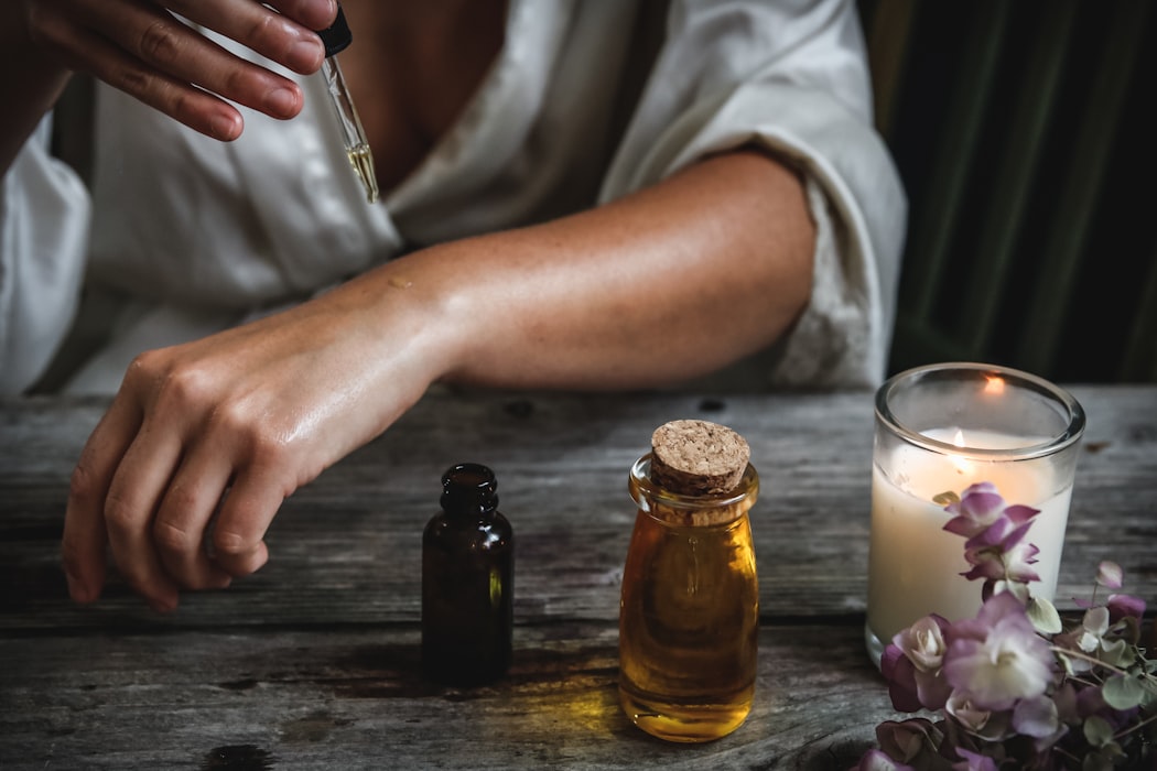 woman applies some essential oils to the skin