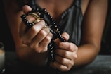 woman holding prayer beads