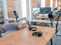 two black headphones on brown wooden table