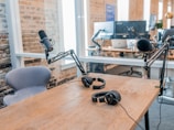 two black headphones on brown wooden table