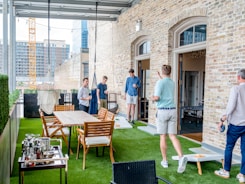men playing cornhole boards
