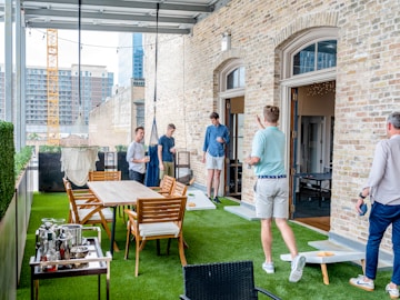 men playing cornhole boards