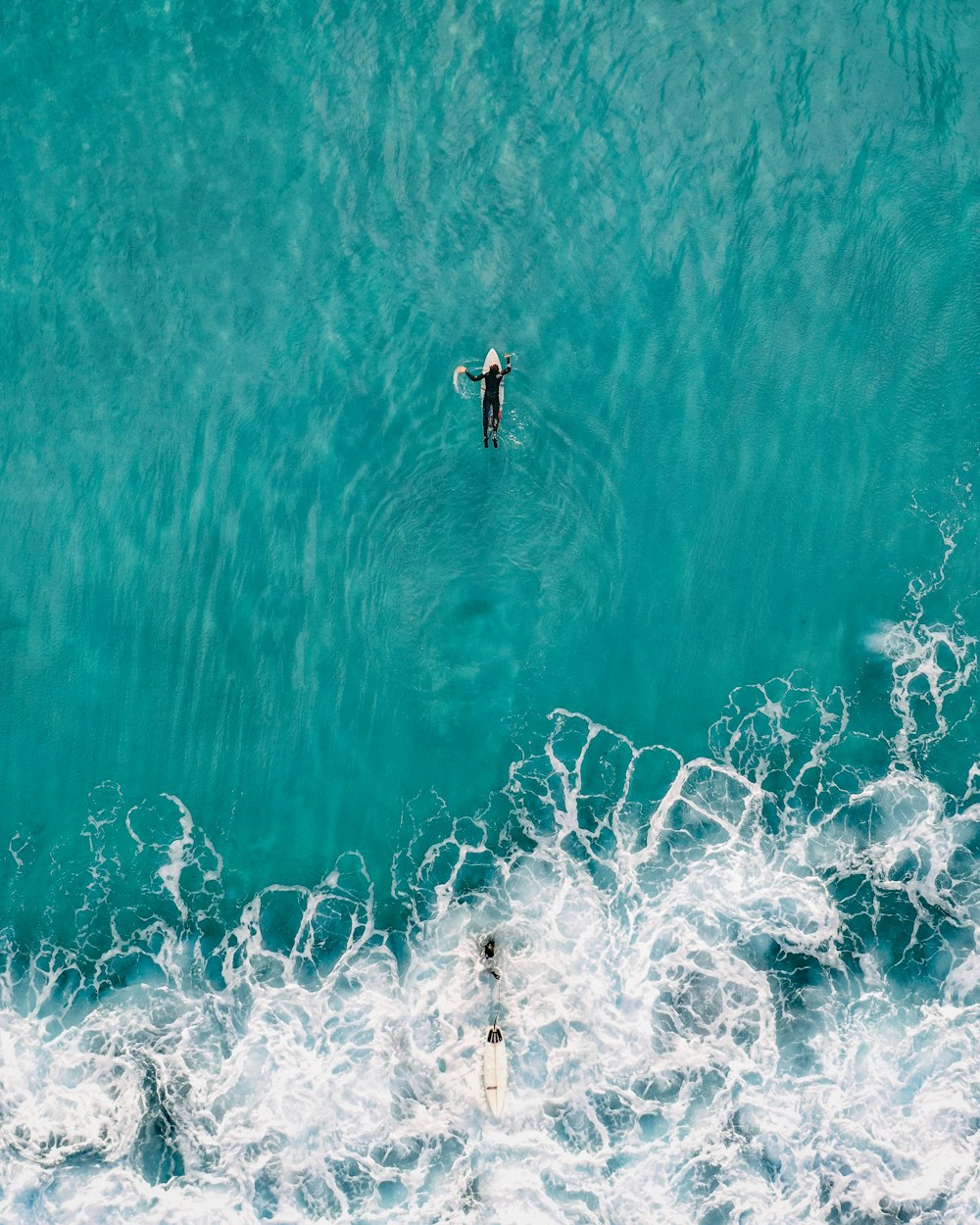 person on white surfboard