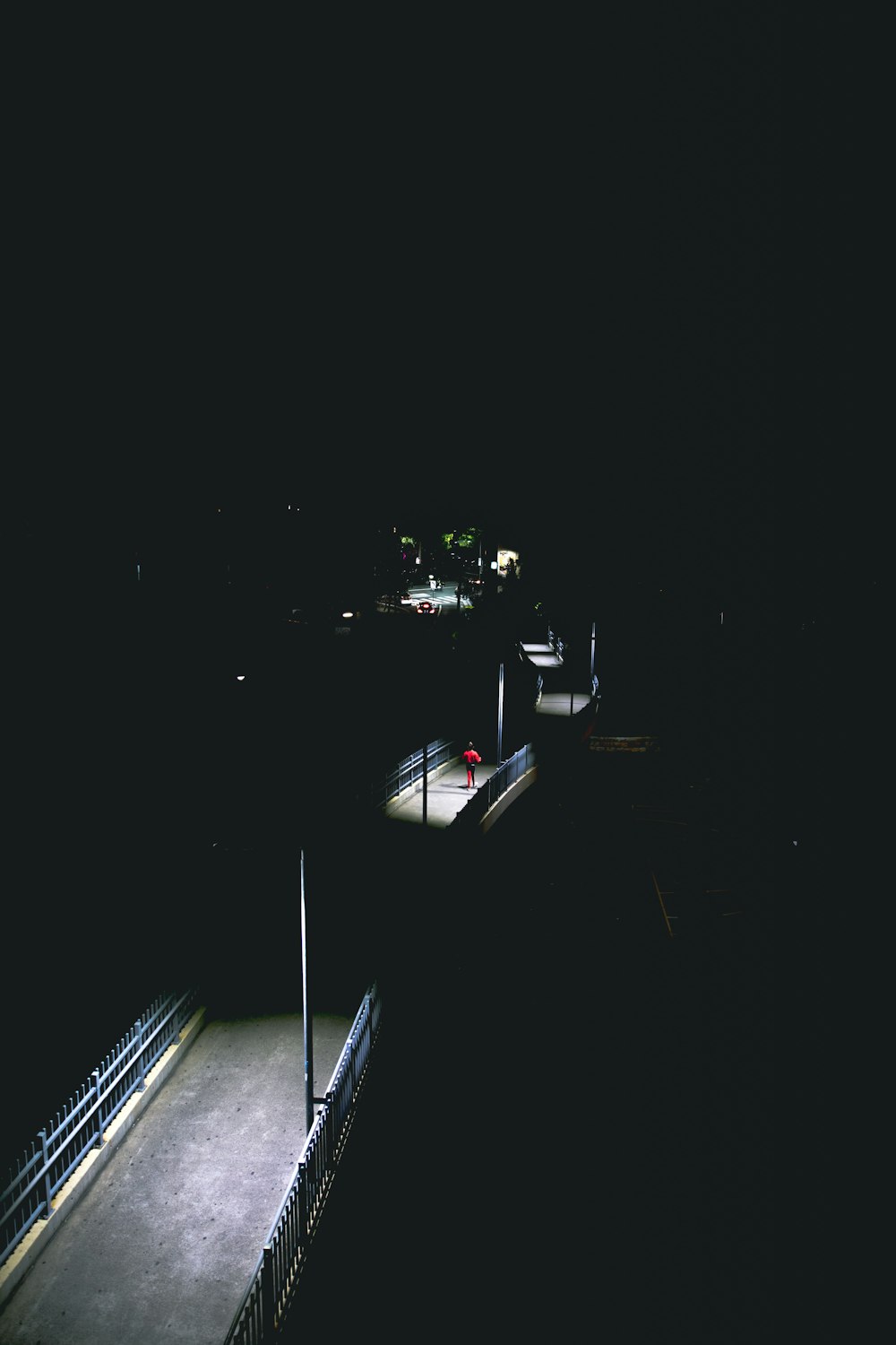 a dark picture of a street at night