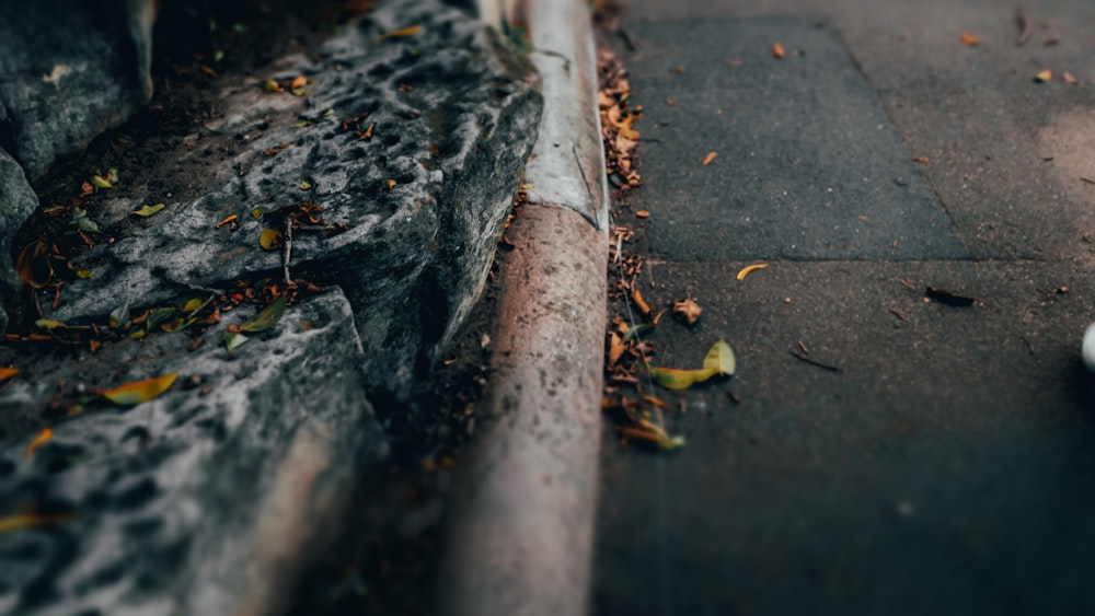 a person walking down a street next to a curb