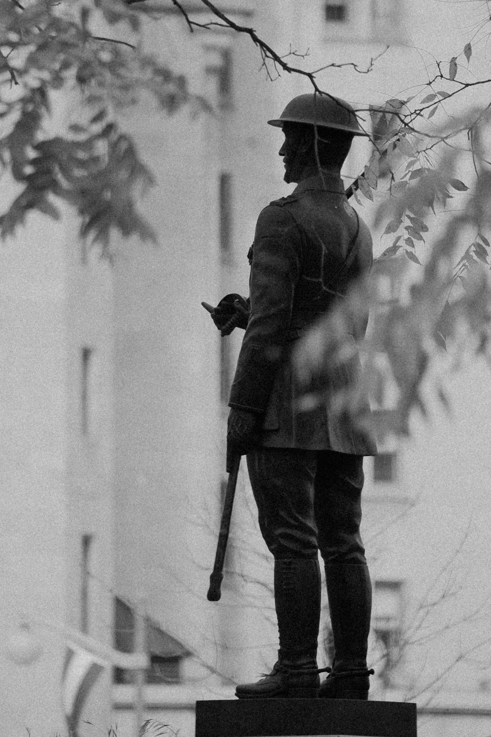 standing soldier statue near tree