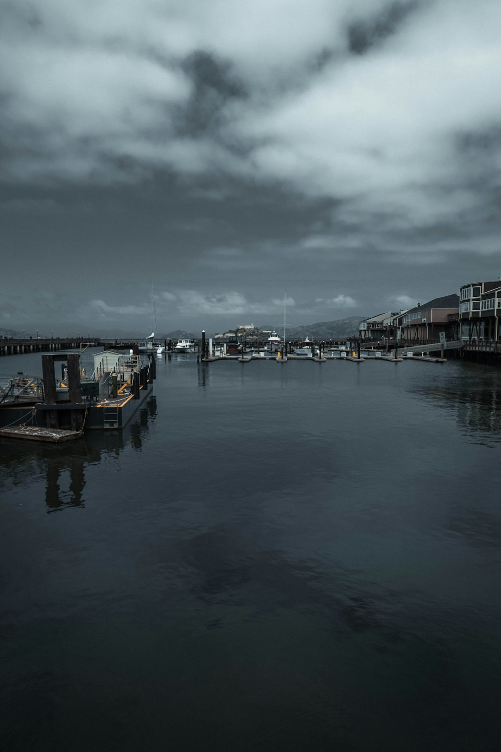 grayscale photo of body of water and building