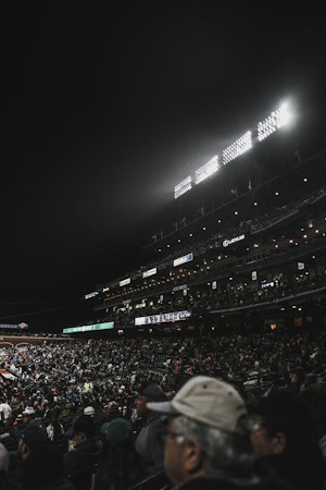 Fans filling a stadium at night under bright lights, like the crowds expected for glow-in-the-dark baseball in Summerlin