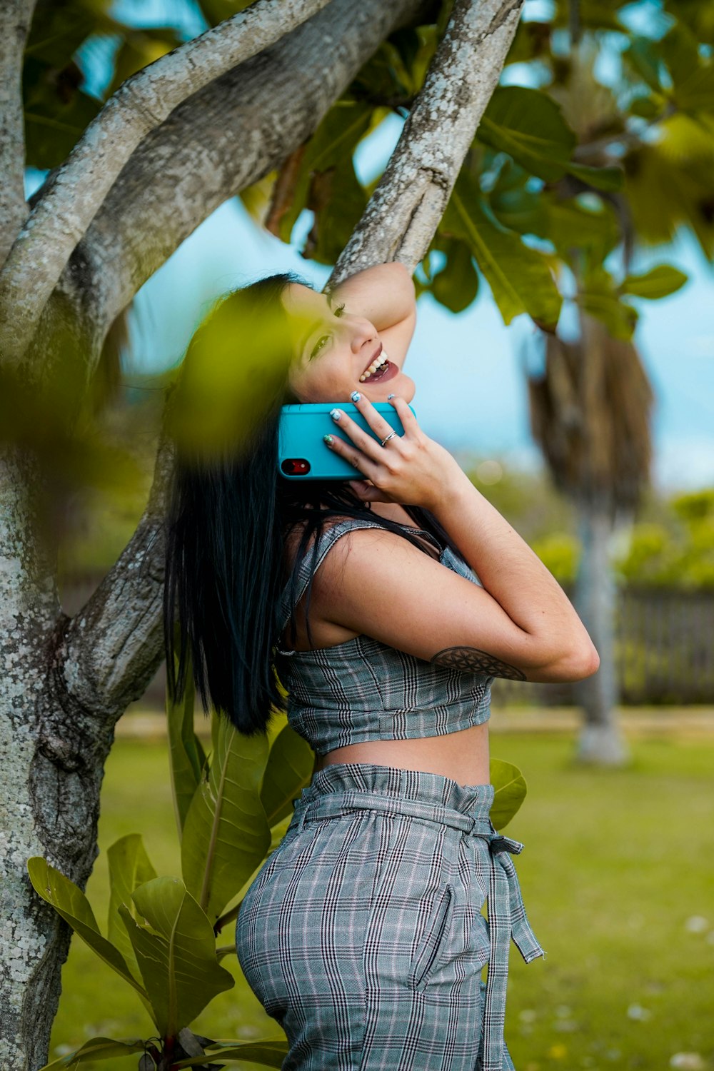 woman listing on to blue smartphone