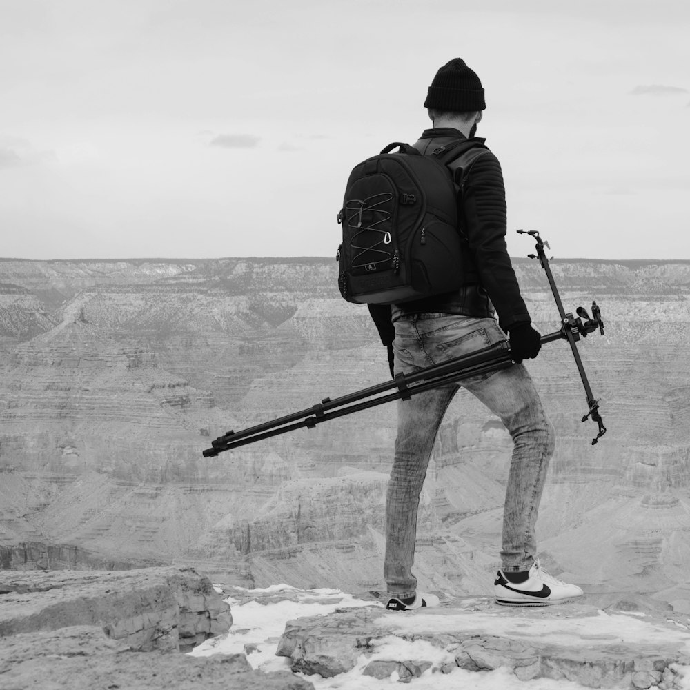 man holding black monopod stand