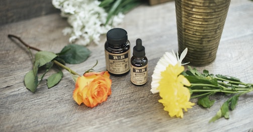 yellow rose flower and two assorted-color petaled flowers