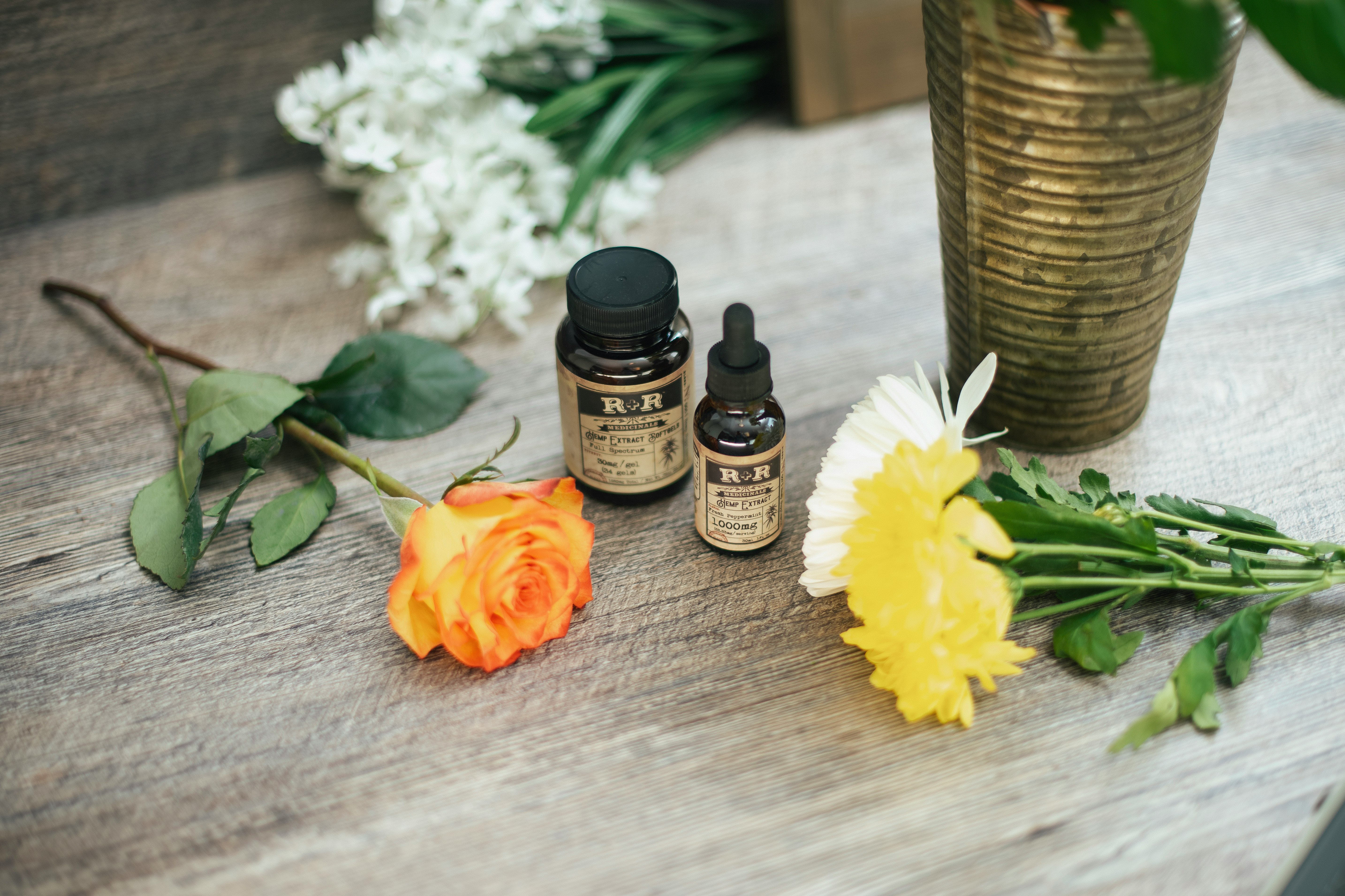 yellow rose flower and two assorted-color petaled flowers