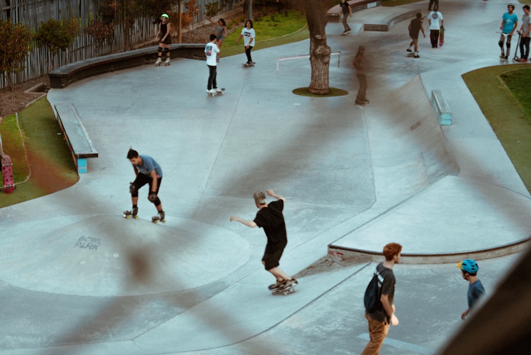 men playing skateboard near skateboard play yard during daytime