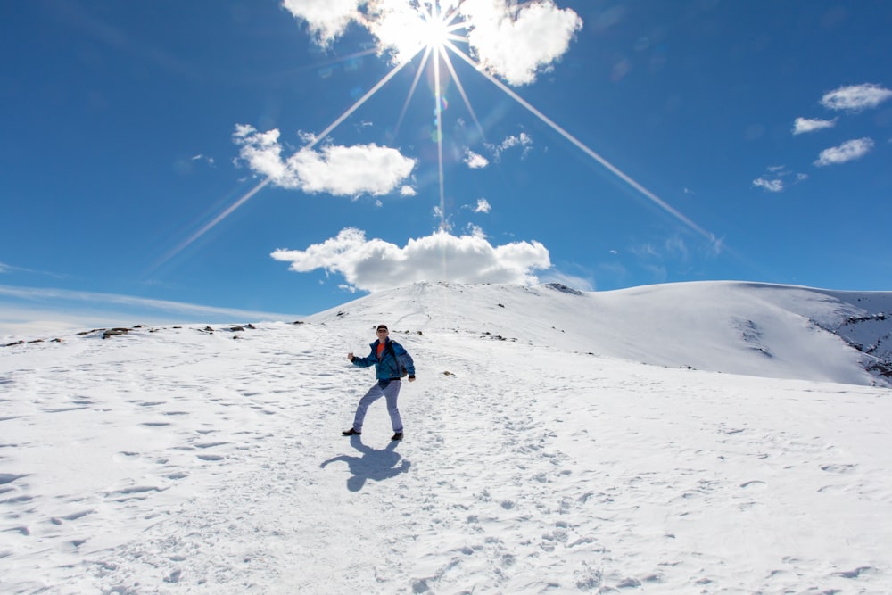 man standing on snowfield during daytime