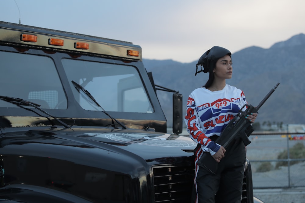 woman standing beside black vehicle