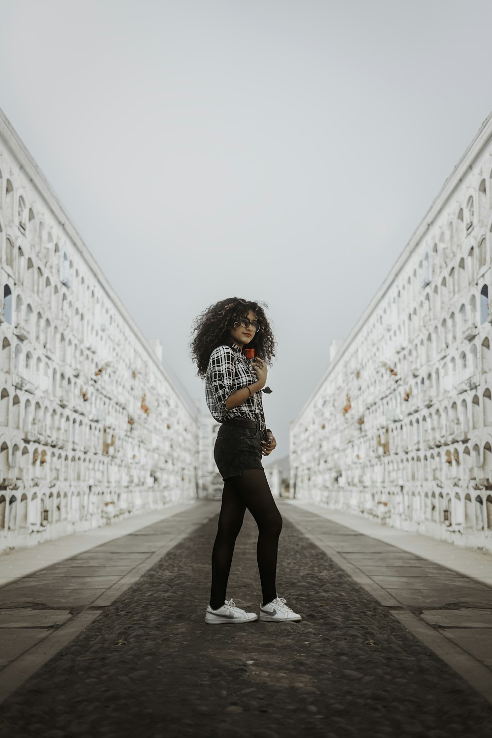 woman standing between white walls