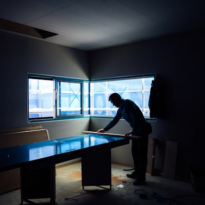 silhouette photography of man inside dim-lighted room