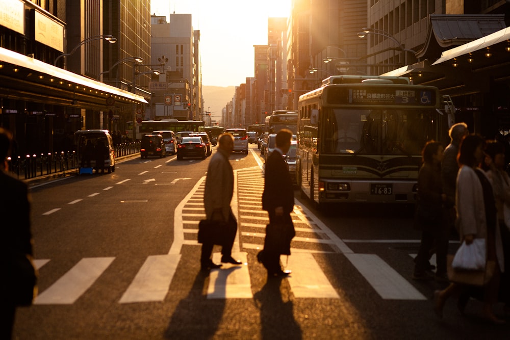 silhouette photography of men crossing pedestrian lane in the city