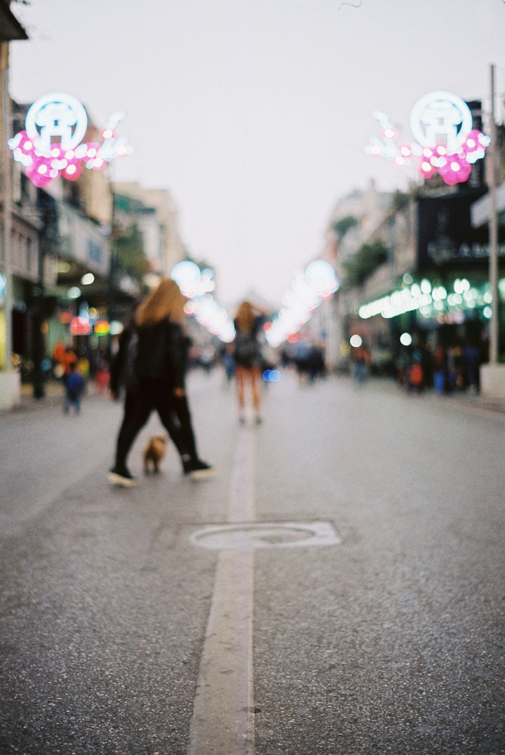 a couple of people walking down a street