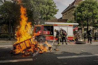 firemen putting out fire during daytime