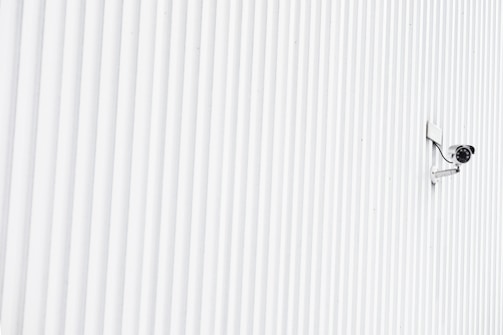 High-end security camera discreetly mounted in a minimalist home entryway.