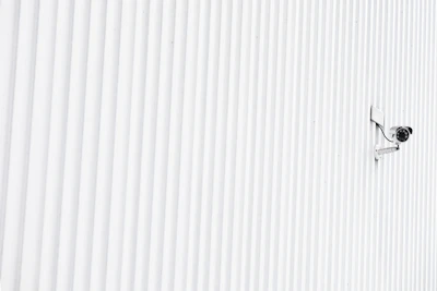 A sleek WiFi security camera mounted on a modern living room wall