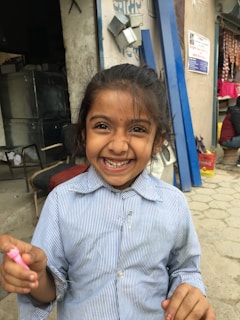 Smiling young girl wearing a colorful, trendy outfit from isabelaemaysastore outdoors