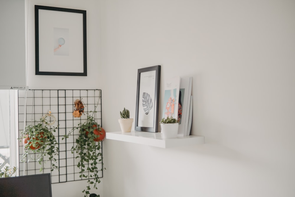 black wooden frame on whit hanging shelf