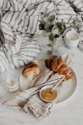 An inviting breakfast setup bathed in natural light with elegant gold touches.
