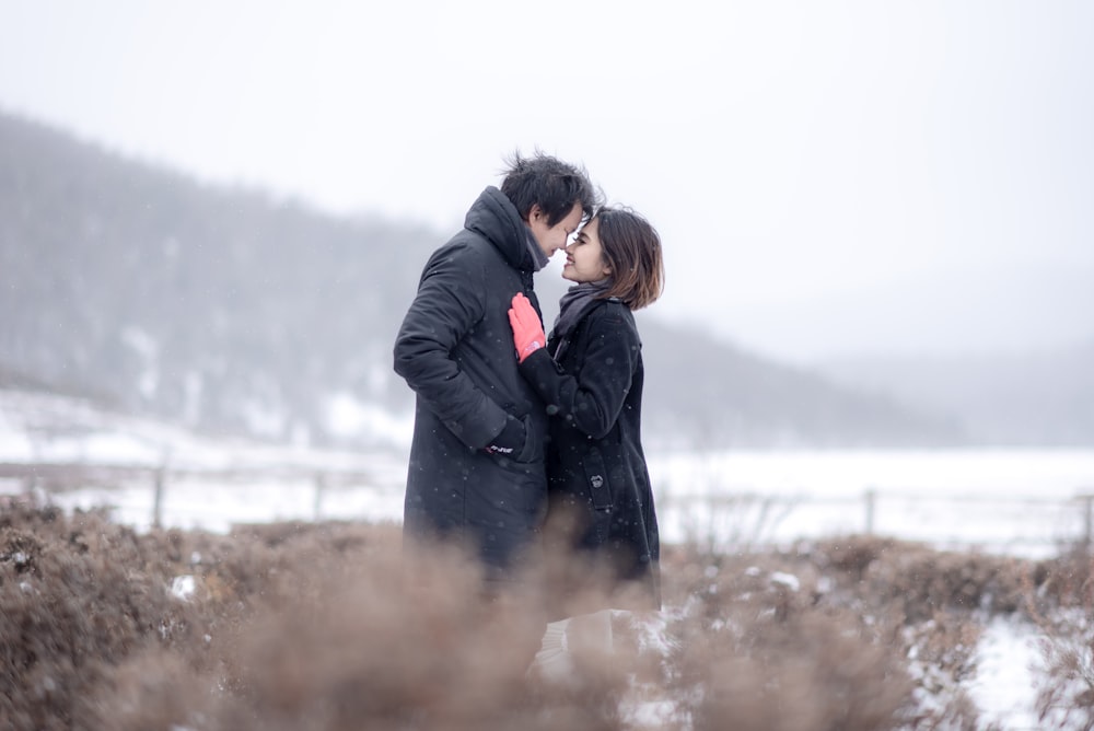 couple standing on snow field